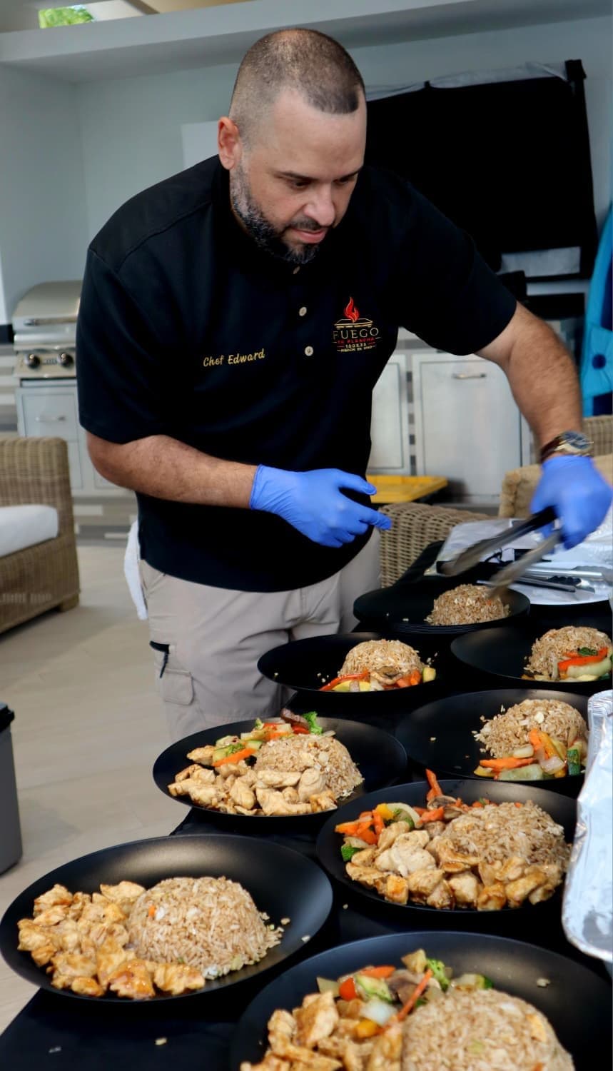 Chef Edward plating teppanyaki at an at-home hibachi dinner